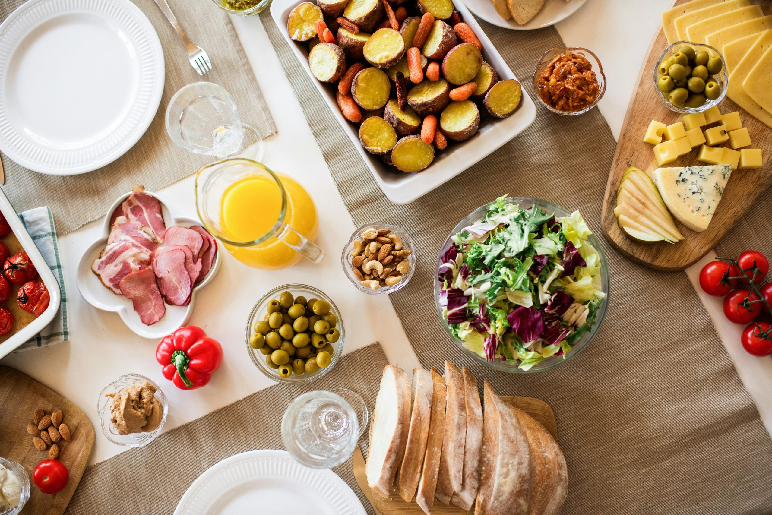 dinner table, set with roast vegetables, salad, meat and bread