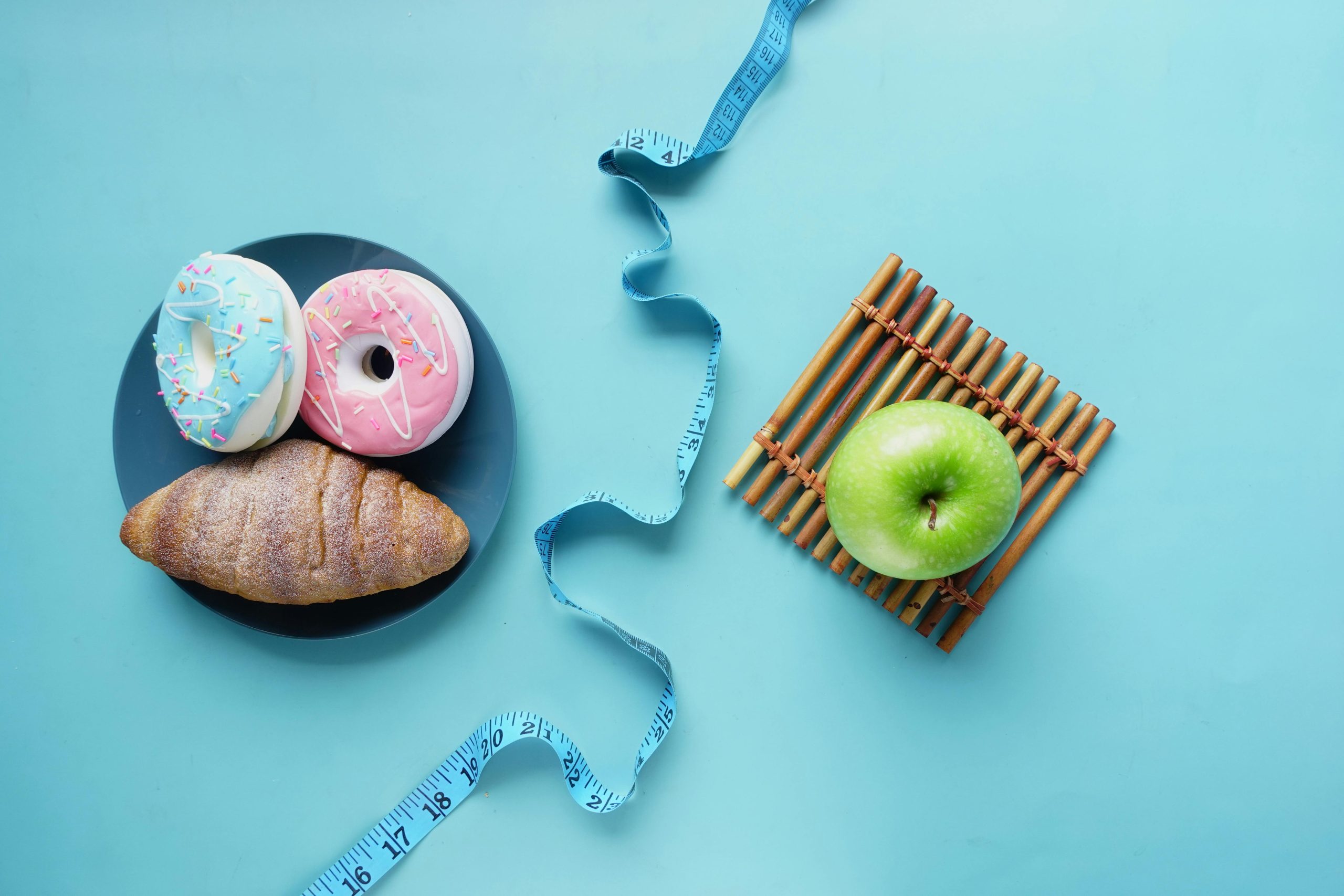 donuts and croissant, measuring tape and apple