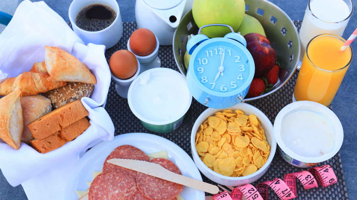 A variety of food with a measuring tape and clock to the side.